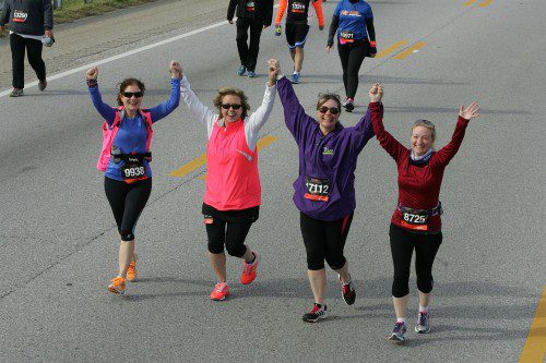 Molly, in blue, embodies the “community” spirit of running – even in her race pictures! 